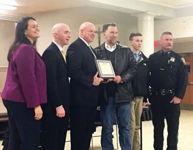 John O’Toole (fourth from left) was presented with a Boston Police Department certificate that commends his actions in identifying a bank robbery suspect last month. O’Toole is a past president of the Cedar Grove Civic Association. Kristina Carroll photo